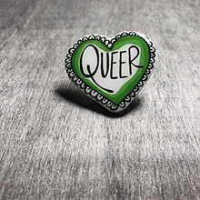Load image into Gallery viewer, The pin is heart shaped and says the word "Queer" in the center. The color is blue