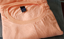 Load image into Gallery viewer, Our cantaloupe colored shirts.